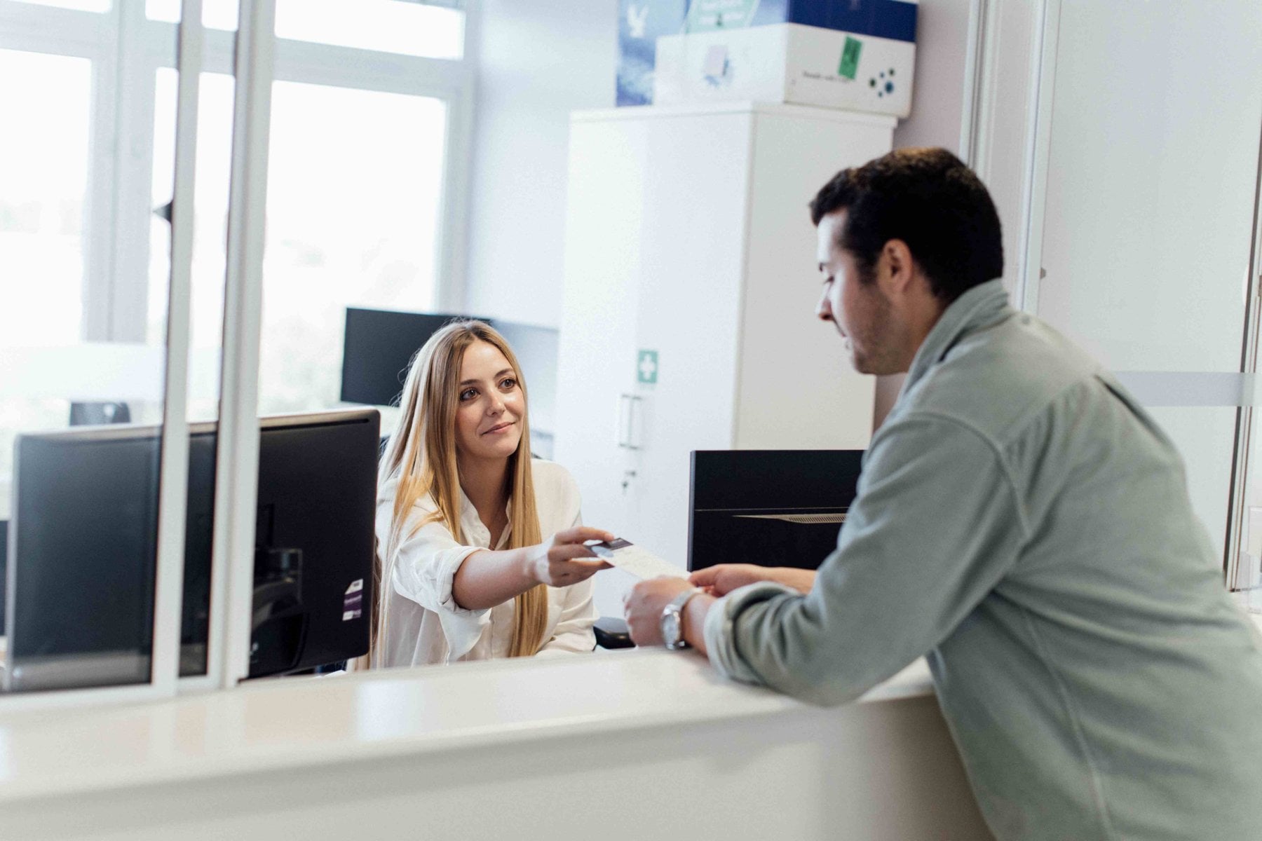 A patient being welcomed at the Mayfield Clinic reception